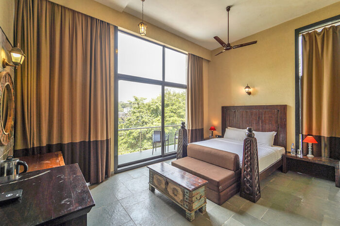 Premium room with balcony at a hotel in Lonavala with swimming pool, ideal for relaxing weekend getaways near Mumbai